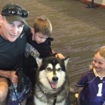 Dr. Carey with his kids and his Husky