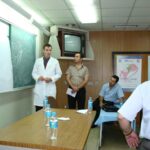 Dr. Carey explaining surgical approach of orbit to Iraqi doctors to remove an imbedded IED (Improvised Explosive Device)